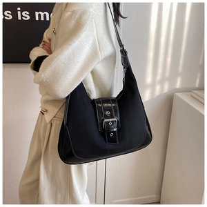Detail view of black vintage matte leather hobo bag with glossy strap and silver buckle