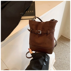 Deep brown matte leather bucket bag with silver buckle and crossbody strap detail