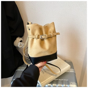 Yellow and black contrast suede bucket bag with leather buckle and long shoulder strap