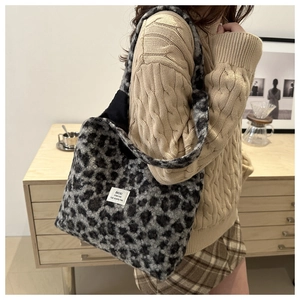 Detailed view of leopard print plush tote bag with white tag on fuzzy material