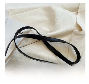 Detailed close-up of premium black leather shoulder strap with smooth finished edges