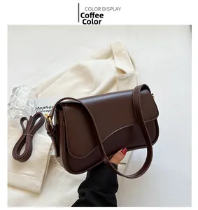 Detailed close-up of brown faux leather shoulder bag with gold hardware and flap closure