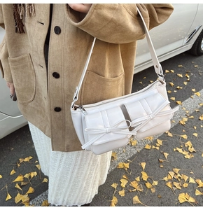 Chic white PU leather underarm bag with bow details and adjustable silver hardware