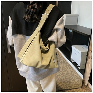 Detail view of olive green suede hobo bag with adjustable wide strap and silver buckle