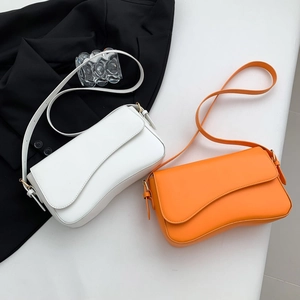 Minimalist solid color crossbody flap bag in white and orange with gold hardware detail