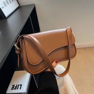 Brown matte leather shoulder bag with flap closure and decorative stitching for women