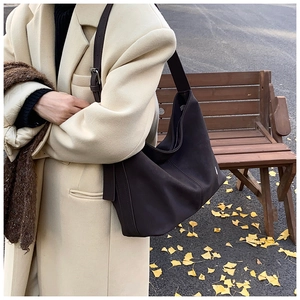 Detail of chocolate brown PU leather hobo bag showing spacious design and strap buckle