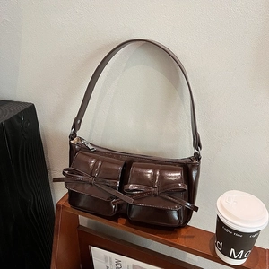Retro brown PU leather baguette shoulder bag with chic bow accents and dual front pockets
