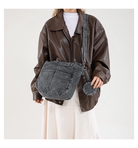 Détail du sac bandoulière en denim gris délavé avec sangle réglable et petit porte-monnaie