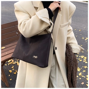 Deep brown PU leather crossbody bag with decorative stitching and bean-shaped metal buckle
