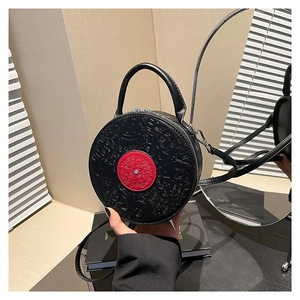 Fashionable round black PU leather crossbody bag with red disc detail and face embossing