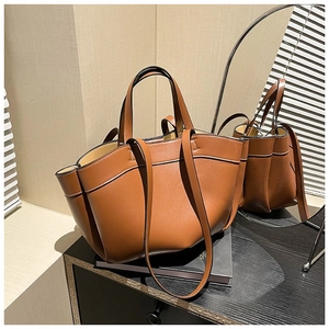 Caramel brown leather tote bag with wide opening and double straps for commuting