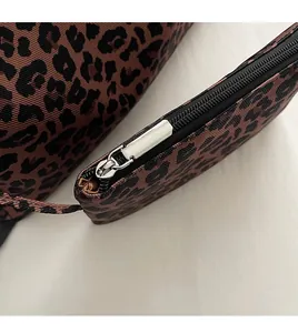Detail of high-quality silver metal zipper on leopard print canvas tote bag