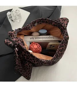 Macro view of leopard print tote bag interior with magnetic snap showing large capacity