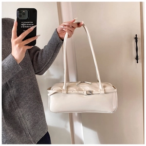 Chic cream leather shoulder bag with decorative buckle and dual zipper detail