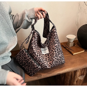 Detail of leopard print tote bag and matching pouch in soft fabric with urban style