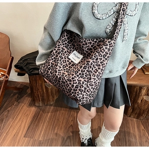 Fashionable leopard print canvas tote bag with wide strap styled with casual outfit
