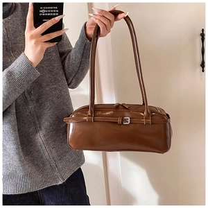 Mirror selfie showing the side view of a dark brown PU leather baguette shoulder bag