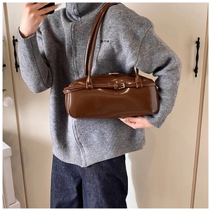 Brown patent leather baguette bag with silver buckle detail and thin shoulder straps