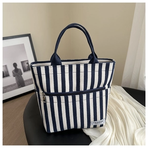 Chic blue and white striped canvas tote bag with fashion label and front zip pocket