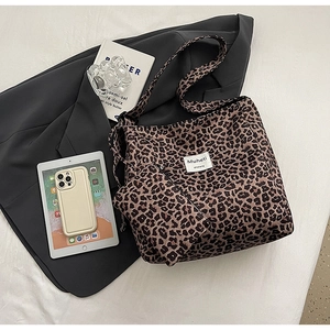 Detail of leopard print tote bag and matching pouch on elegant lifestyle background