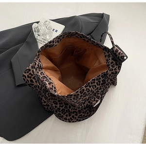 Top view of leopard print canvas tote bag showing brown fabric lining and inner pocket