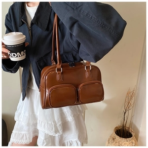Brown faux leather shoulder bag featuring dual front pockets and glossy retro finish