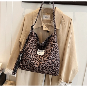 Large leopard print canvas tote bag with shoulder straps and small zipper pouch accessory