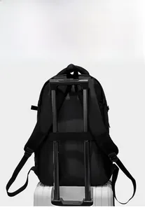 Detail view of business backpack with luggage strap attached to silver suitcase handle