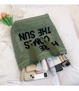 Detail of green woven tote bag filled with tablet and phone showing large storage capacity