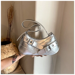 Detailed close-up of Y2K silver metallic underarm bag with buckles and eyelets