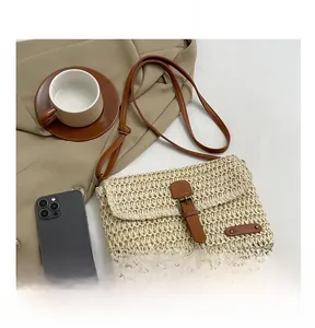 Detailed macro of woven straw texture and premium brown leather straps on summer beach bag