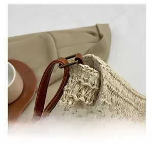 Close-up of straw woven bag texture with brown leather strap and vintage hardware