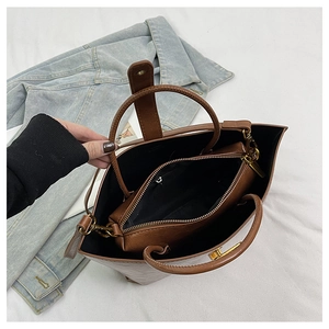 Vue de dessus du cabas en cuir marron avec pochette intérieure zippée et détails dorés