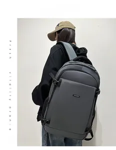 Detailed view of the dark grey minimalist laptop backpack shown on a professional model