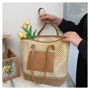 Detail showing beige straw woven tote bag with PU leather handles and decorative tulips
