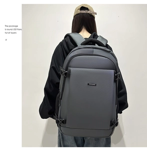 Men's dark gray business backpack shown from a back view on a model with laptop capacity