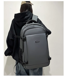 Detail view of grey business backpack with side mesh pocket and adjustable shoulder straps