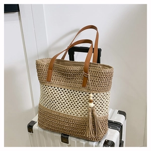 Three-tone striped woven straw tote bag with brown leather handles and wooden bead tassel