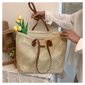 Detail view of the spacious woven straw bag interior with inner pocket and zipper