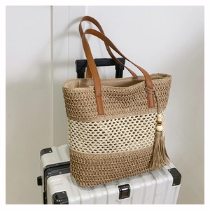 Straw woven tote bag with contrast stripes, leather handles, and bohemian tassel pendant