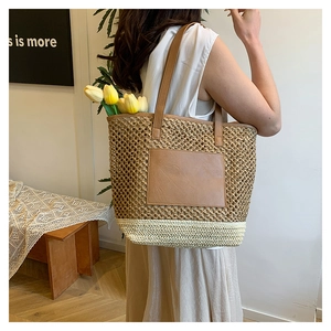 Detail of hand-woven patchwork tote bag with brown leather pocket and shoulder strap