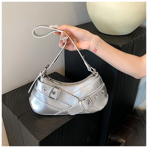 Detailed macro shot of silver metallic underarm bag with Y2K punk style buckle details