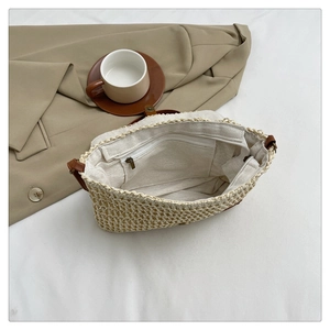 Internal view of straw woven bag with fabric lining and secure metal zipper pocket