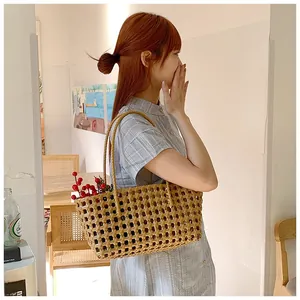 French style hollow woven shoulder bag with natural brown straw texture for beach holidays