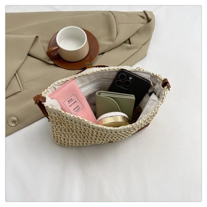 Close-up of woven straw bag interior with zipper pocket and daily essentials storage