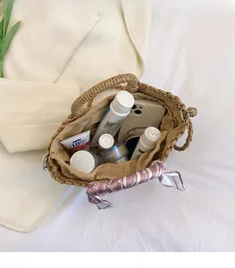 Detail view of woven straw bucket bag showing large interior capacity for cosmetics