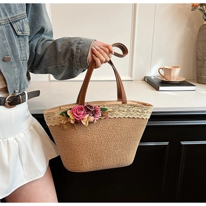 Handmade straw tote bag with brown leather handles and decorative floral lace trim