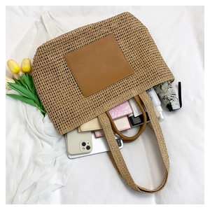 Large capacity straw tote bag showing phone, umbrella, and essentials inside for vacation