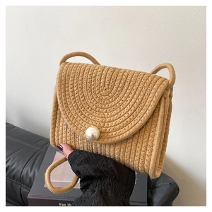 Handmade woven straw crossbody bag with large pearl clasp and thin shoulder strap